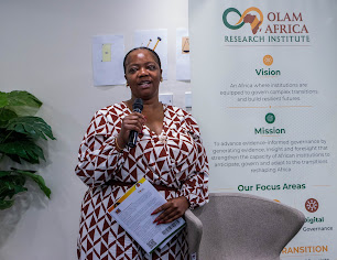 OLAM Africa representative presenting a copy of the research report