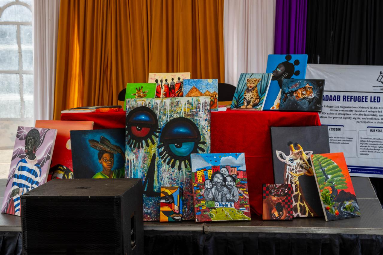A colourful exhibition of paintings depicting people, wildlife, landscapes and expressive abstract forms
