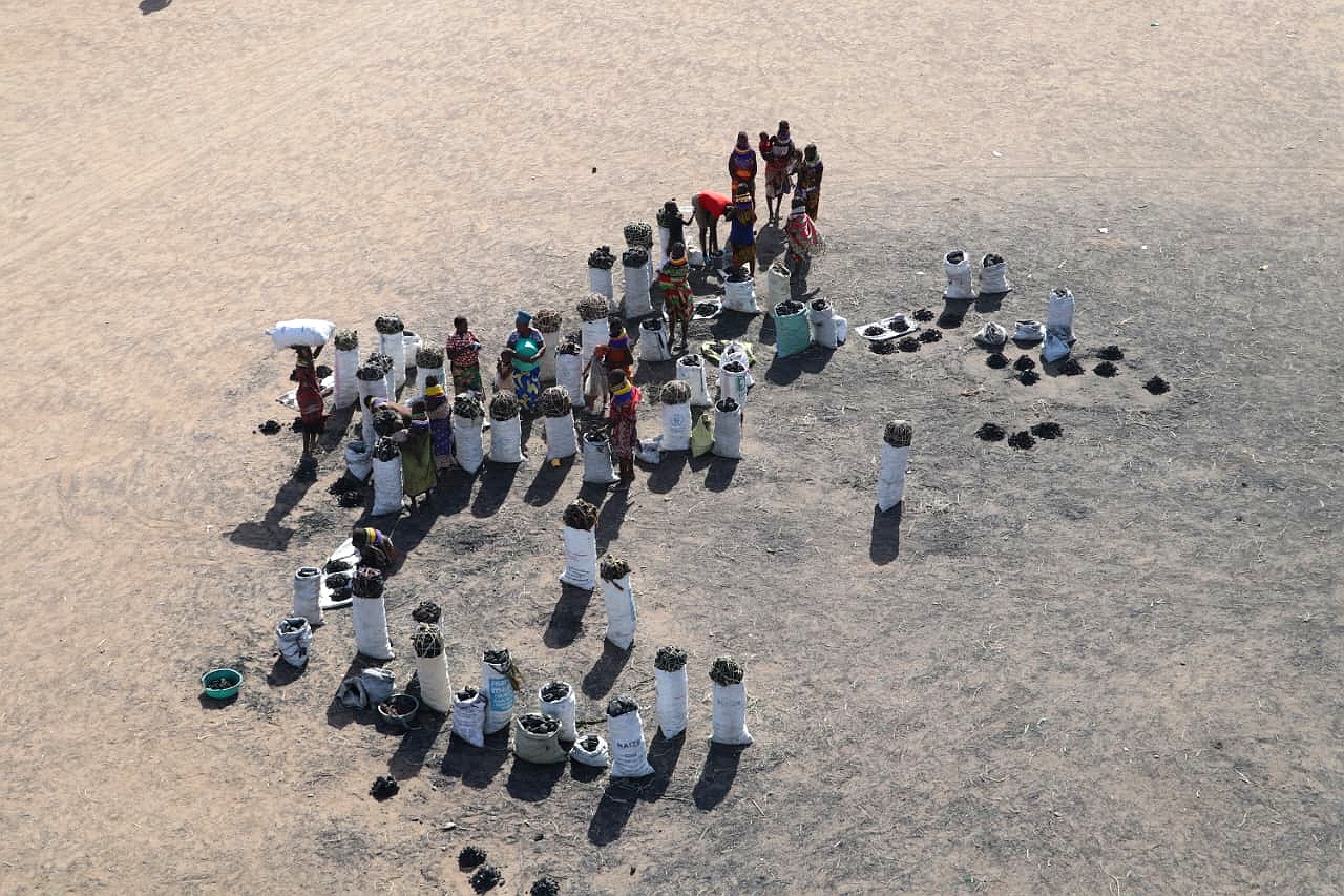 Women walking through a humanitarian settlement, representing resilience and community strength